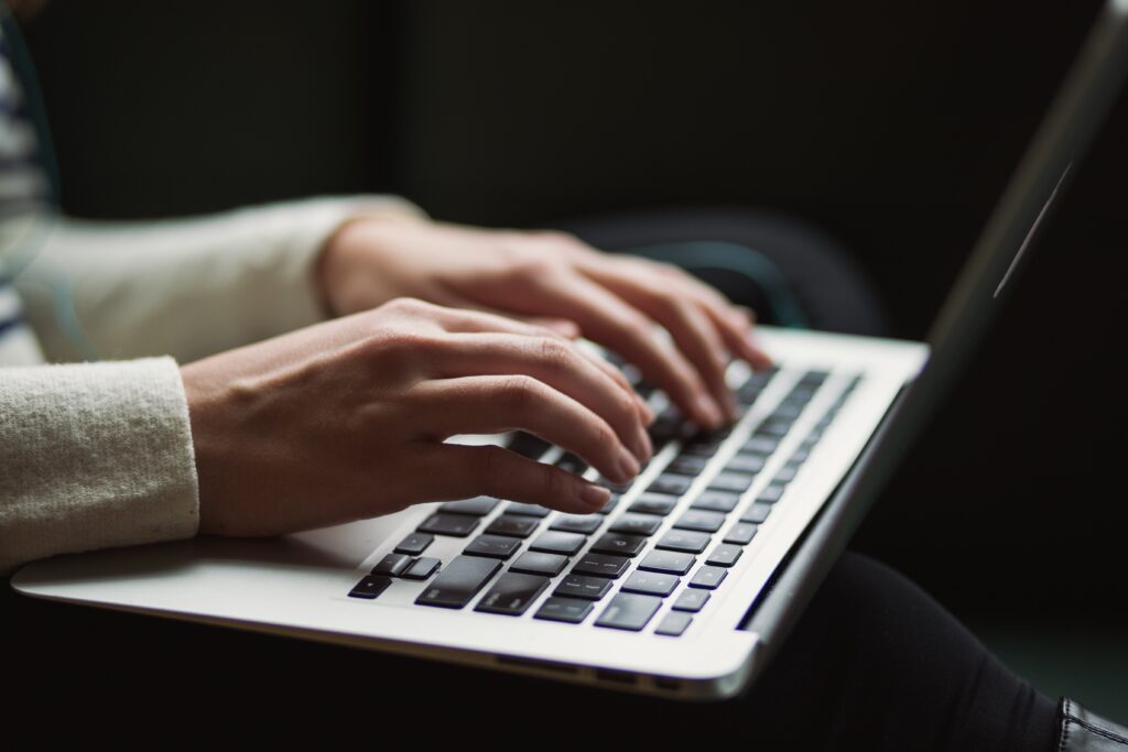 Hands Researching On Laptop